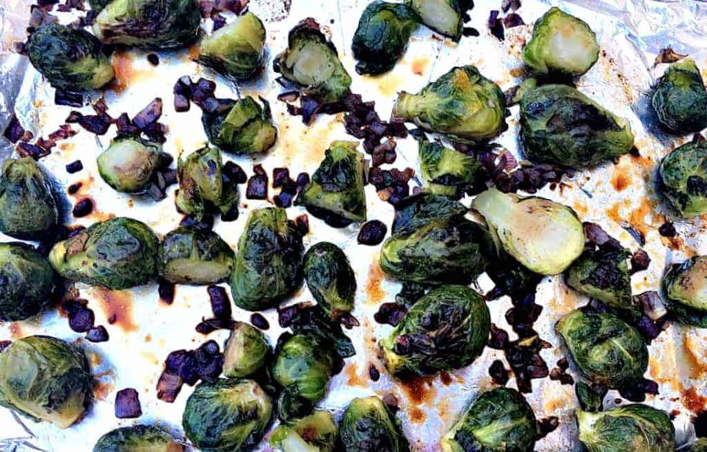 roasted brussels sprouts on a foil lined baking sheet