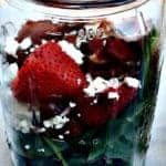 strawberry bacon salad with feta cheese in a mason jar