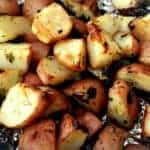 herb roasted potatoes on a foil lined baking sheet