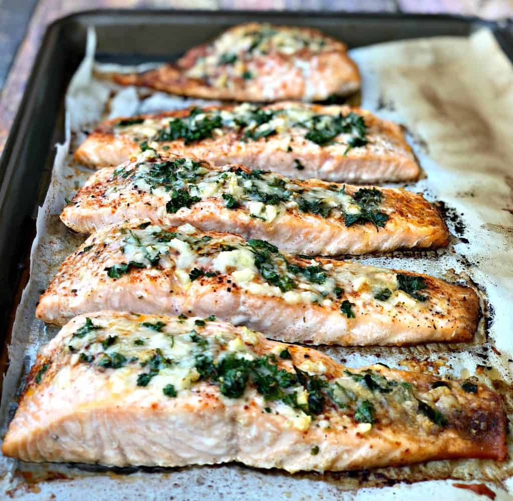 parmesan crusted salmon with herbs on a sheet pan