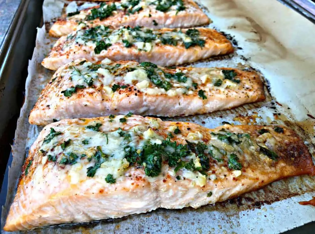 parmesan crusted salmon with herbs on a sheet pan
