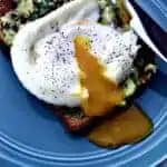 avocado cilantro lime toast with a poached egg on a plate