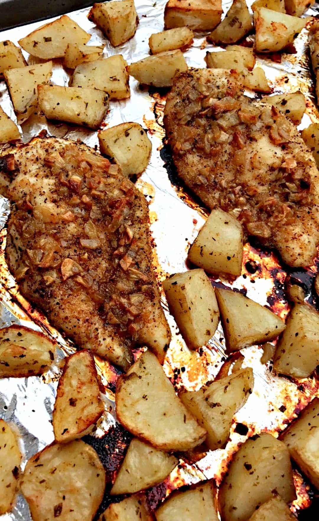 garlic brown sugar chicken and roasted potatoes on a foil lined baking sheet