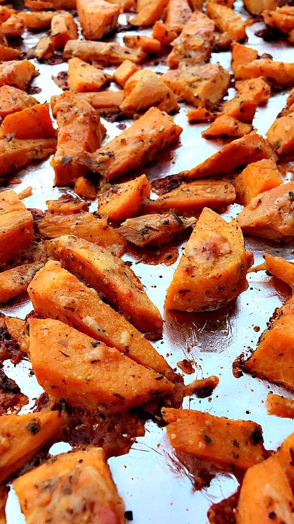 Parmesan Sweet Potatoes on a foil lined baking sheet