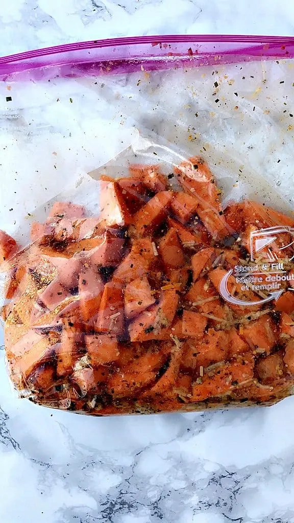 plastic storage bag of sliced, seasoned sweet potatoes