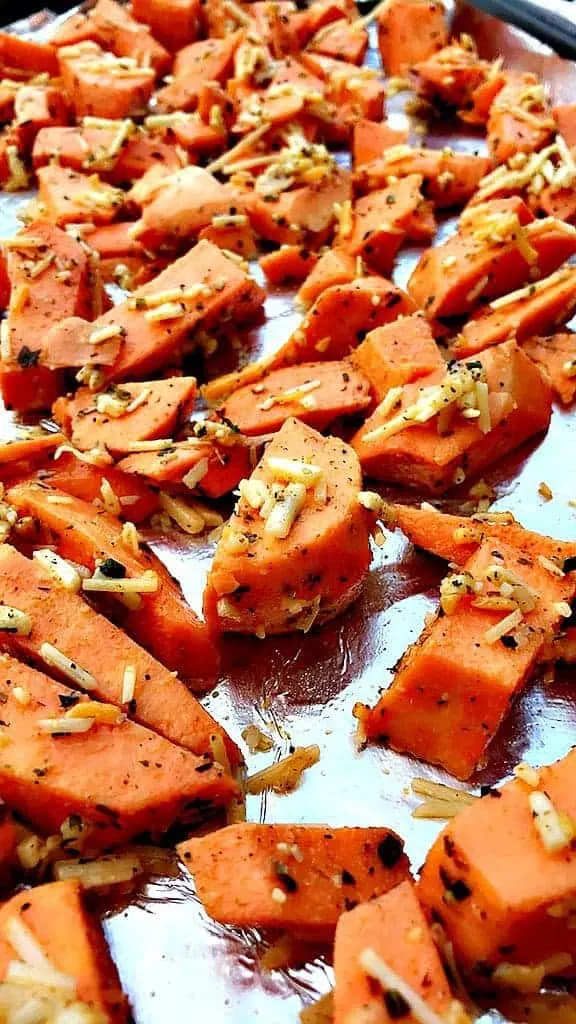 Parmesan Sweet Potatoes on a foil lined baking sheet