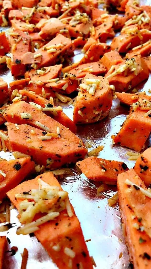 Parmesan Sweet Potatoes on a foil lined baking sheet