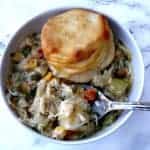 bowl of crock pot chicken pot pie and roll