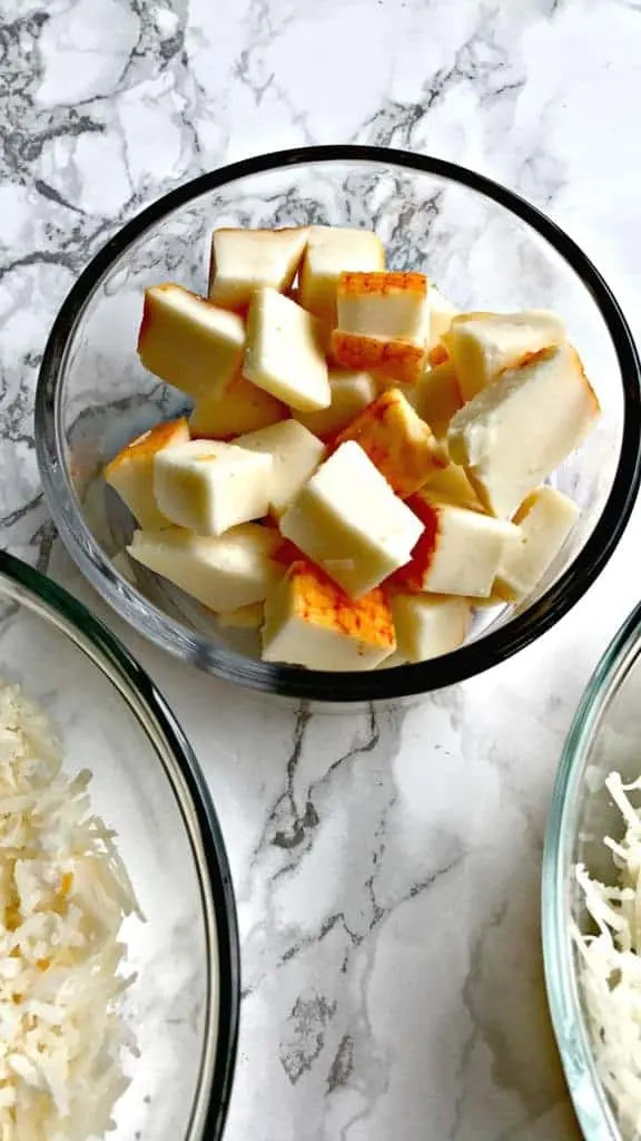 a glass bowl of sliced cheese