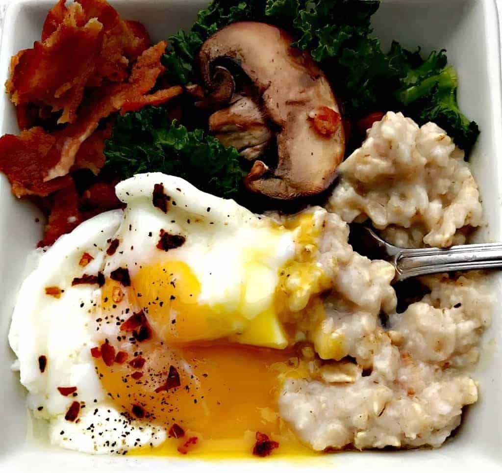 Savory Oatmeal with Bacon Mushroom and Kale Topped with a Poached Egg