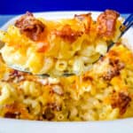 spoonful of bacon gouda mac and cheese over a baking pan