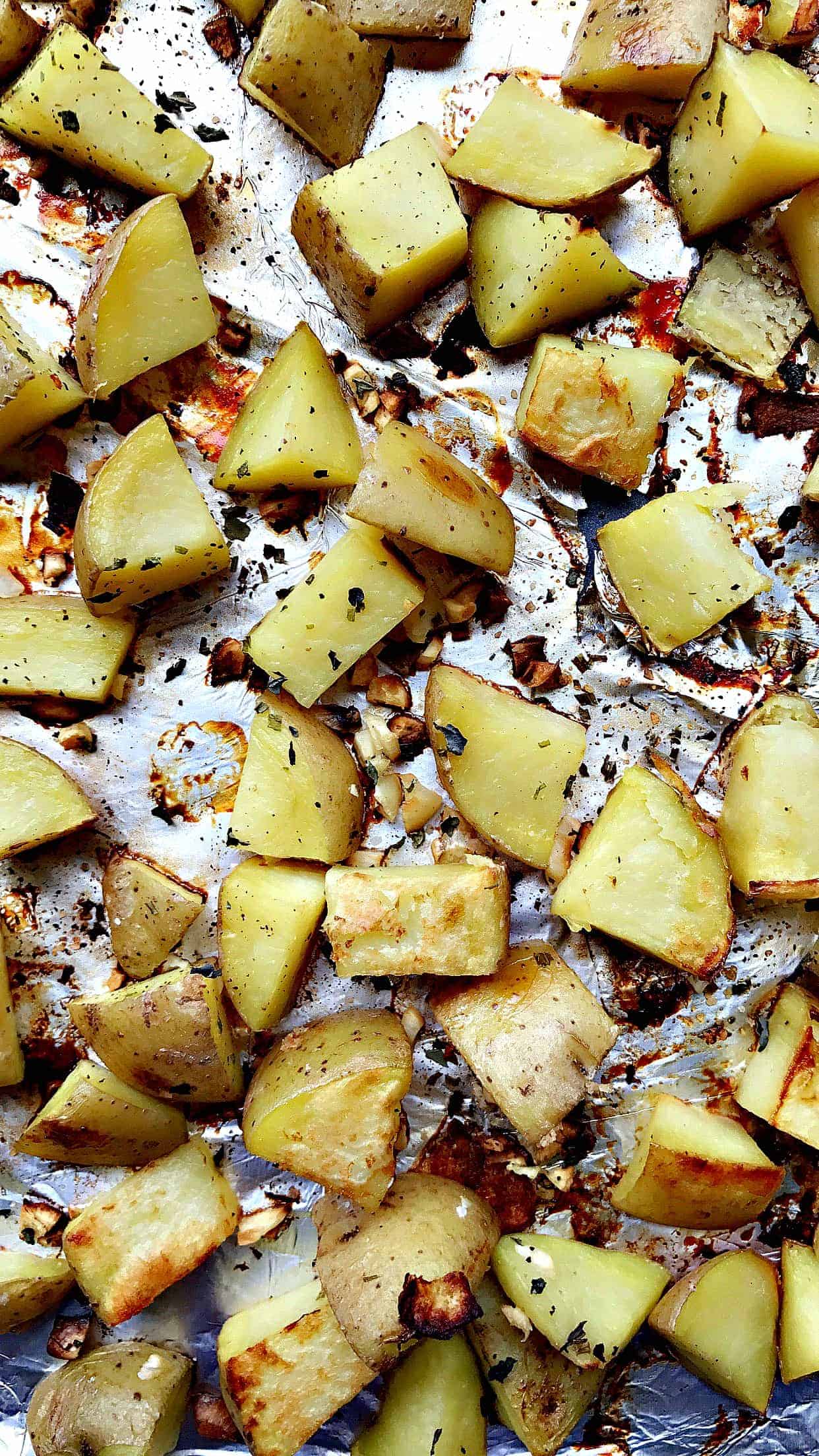 foil lined baking sheet with shopped Yukon potatoes seasoned with honey garlic