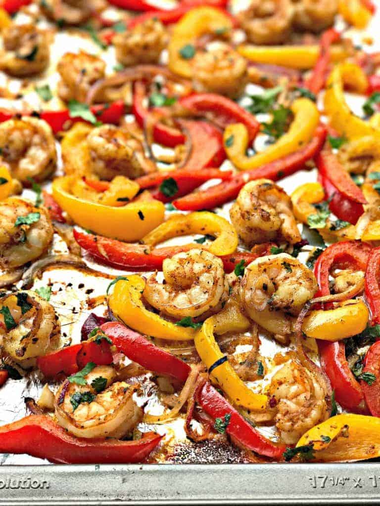 close up of shrimp fajitas on a baking sheet