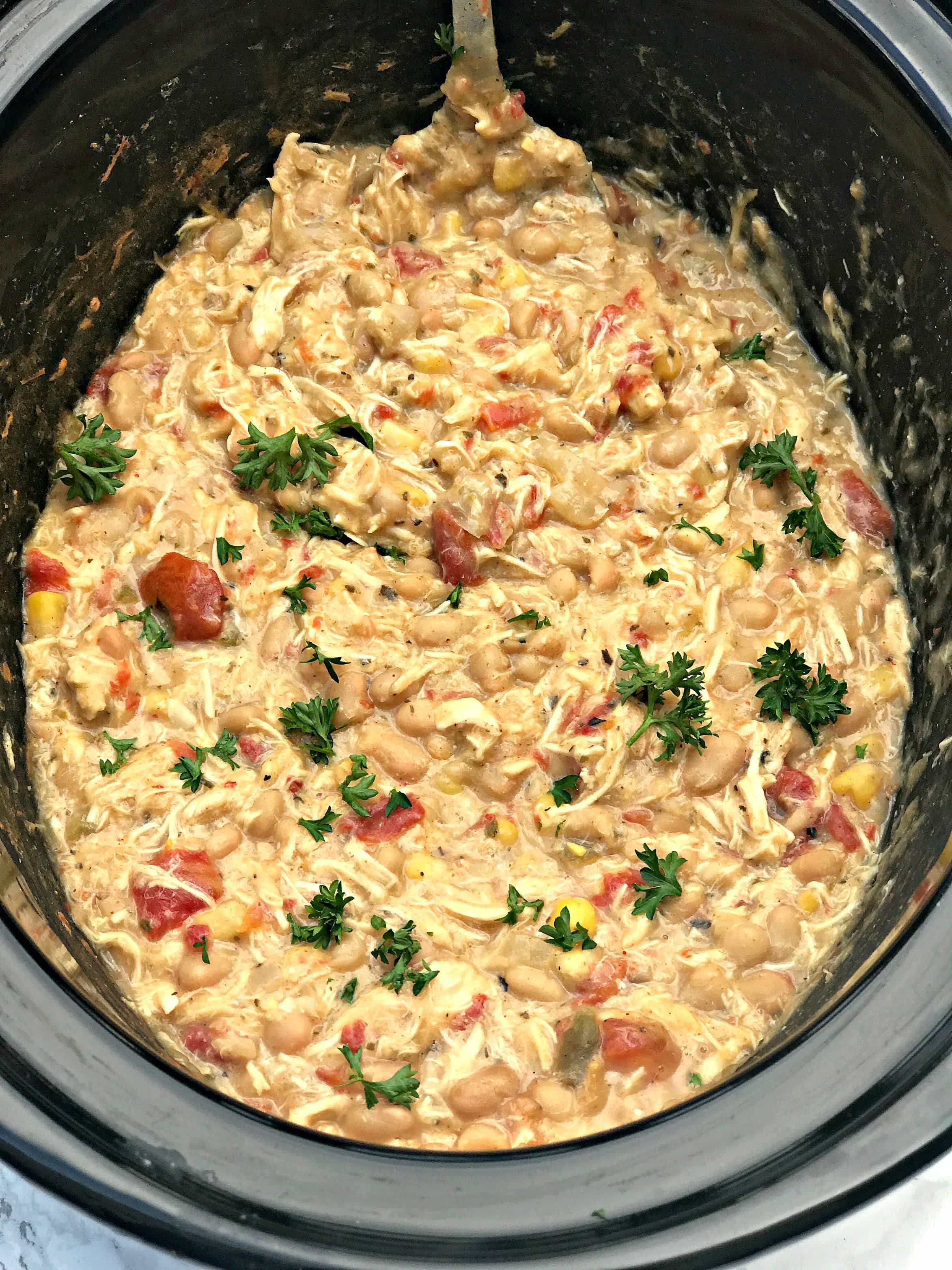 overview of a slow cooker filled with white chicken cihli
