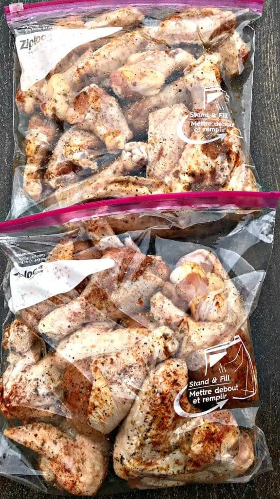 raw seasoned chicken breasts in a ziploc bag