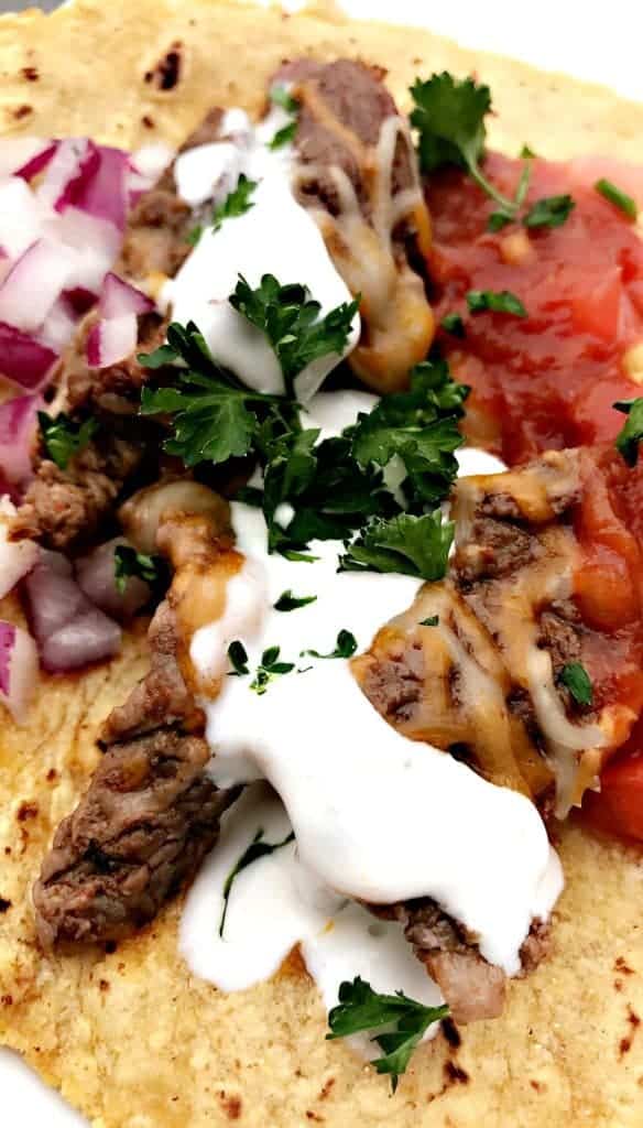 Instant Pot 10-Minute Steak Tacos (carne asada) with melted cheese and sour cream