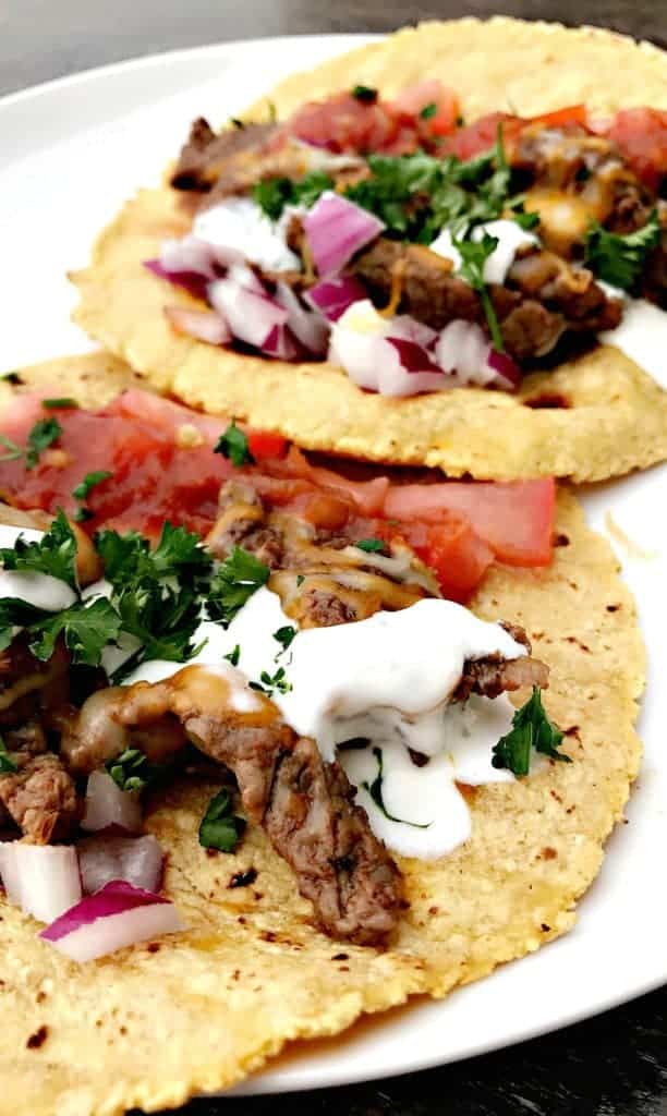 Instant Pot 10-Minute Steak Tacos (carne asada) with melted cheese and sour cream