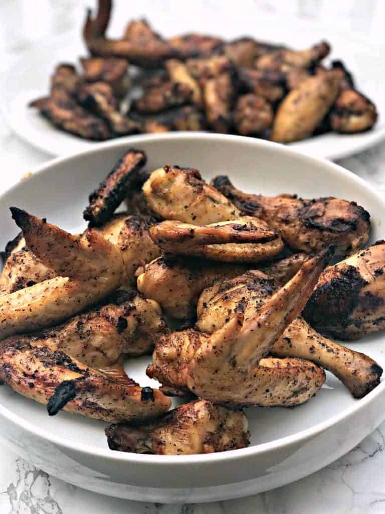 grilled bbq chicken wings in a large white bowl