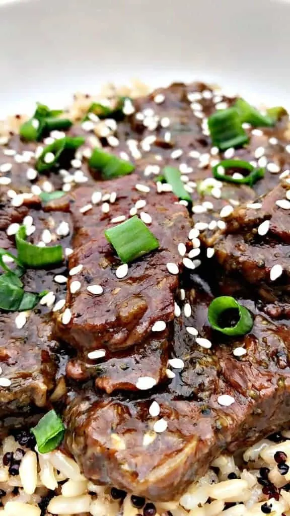 close up of mongolian beef with quinoa and brown rice