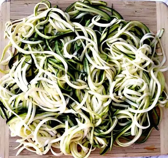 spiralized zucchini noodles on a cutting board