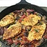 Chicken with Sun-Dried Tomatoes and Mushrooms in White Wine Cream Sauce in a skillet