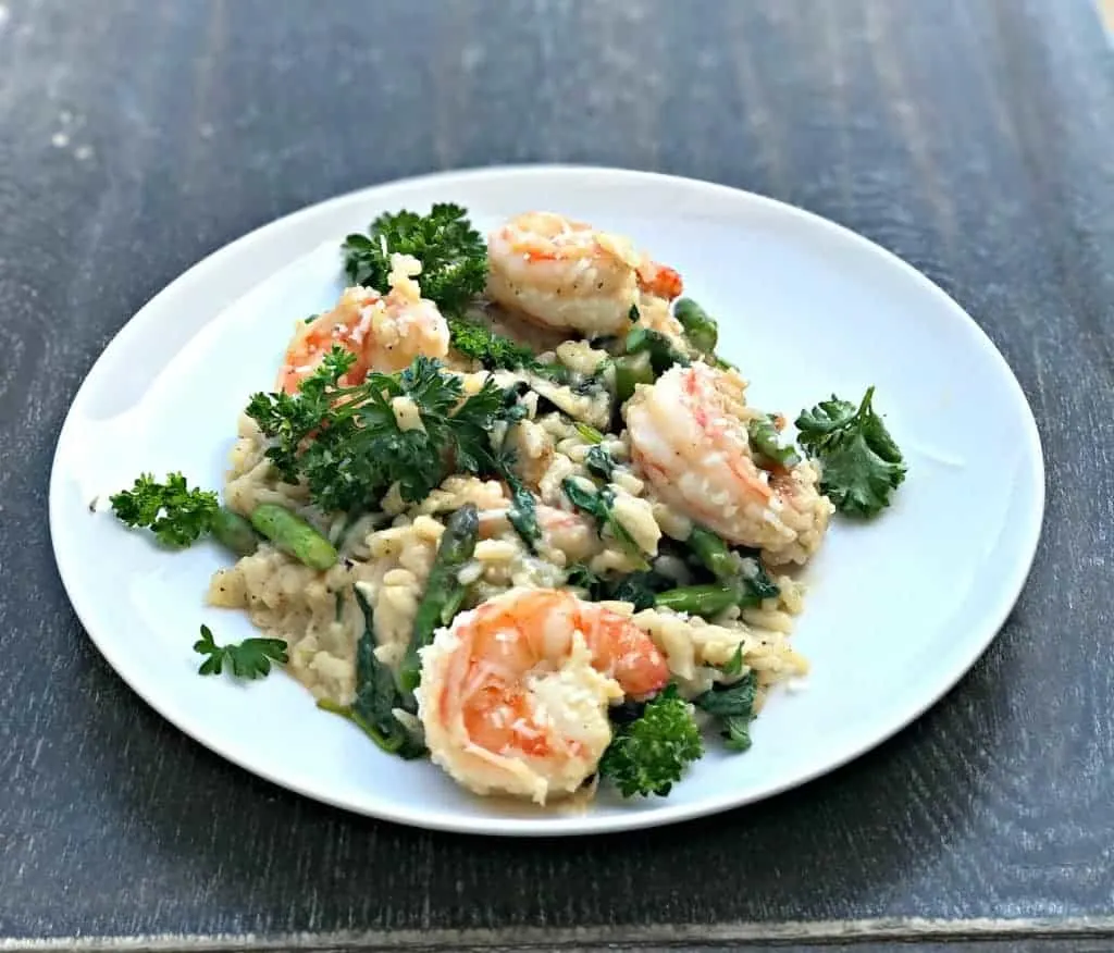 Lemon Shrimp Risotto with Vegetables and Parmesan served on a white plate