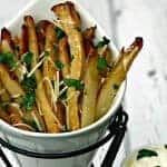 parmesan truffle oil fries in a french fry stand with truffle oil aioli