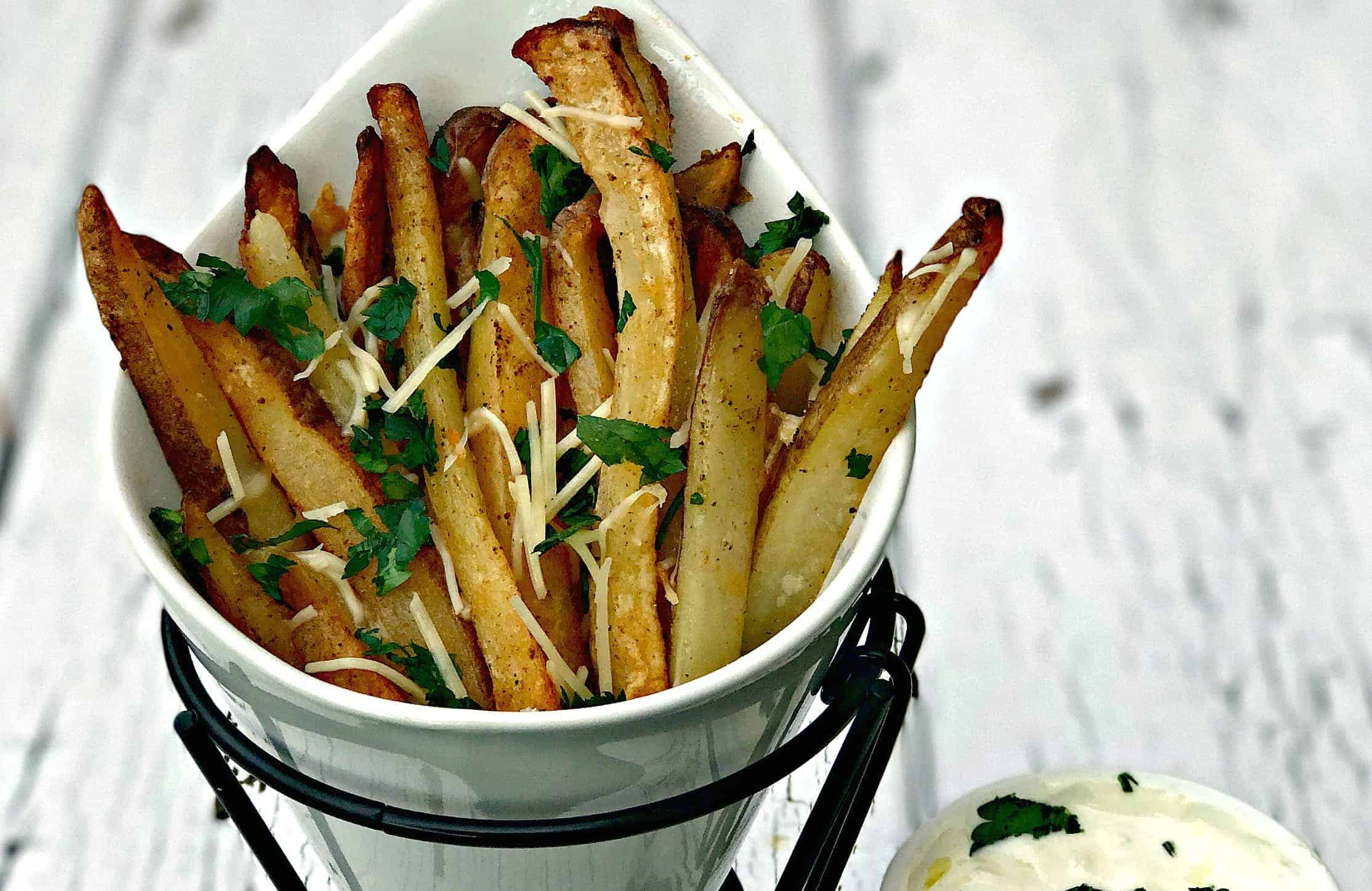 parmesan truffle oil fries in a french fry stand with truffle oil aioli