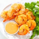 air fryer Bang Bang Panko Breaded Fried Shrimp on a white plate served with a spicy sweet chili sauce