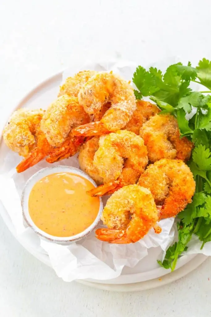 air fryer Bang Bang Panko Breaded Fried Shrimp on a white plate served with a spicy sweet chili sauce