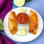 Air Fryer Beef Taco Fried Egg Rolls on a plate with salsa and limes