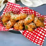 Garlic Parmesan Breaded Fried Chicken Wings in a basket lined with a red and white napkin