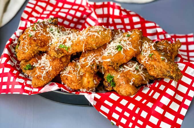 Garlic Parmesan Breaded Fried Chicken Wings in a basket lined with a red and white napkin