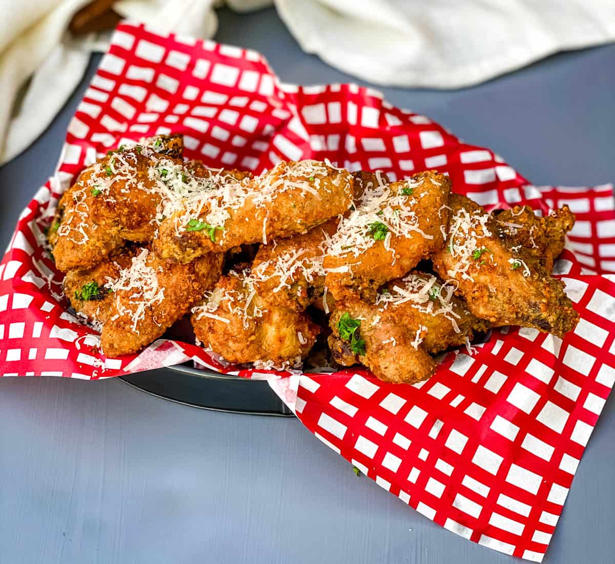 Garlic Parmesan Breaded Fried Chicken Wings in a basket lined with a red and white napkin