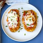 Air Fryer Panko Breaded Chicken Parmesan with Marinara Sauce on a white plate