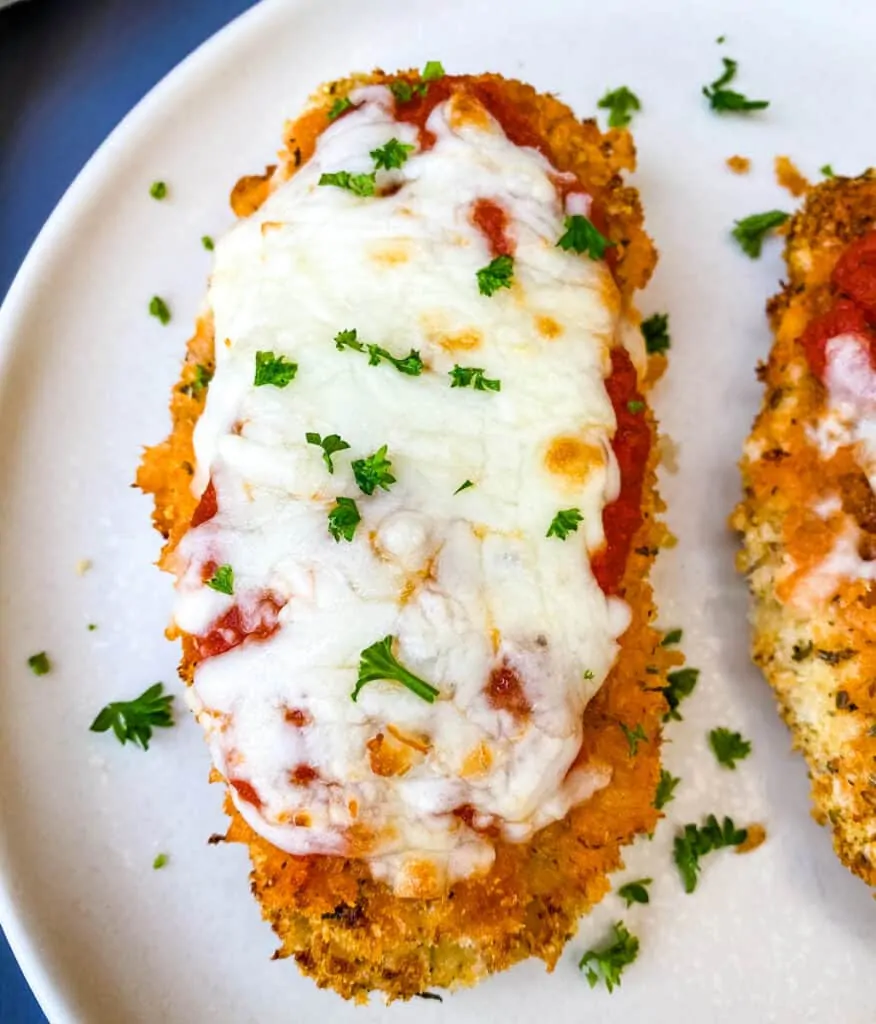 Air Fryer Panko Breaded Chicken Parmesan with Marinara Sauce on a white plate