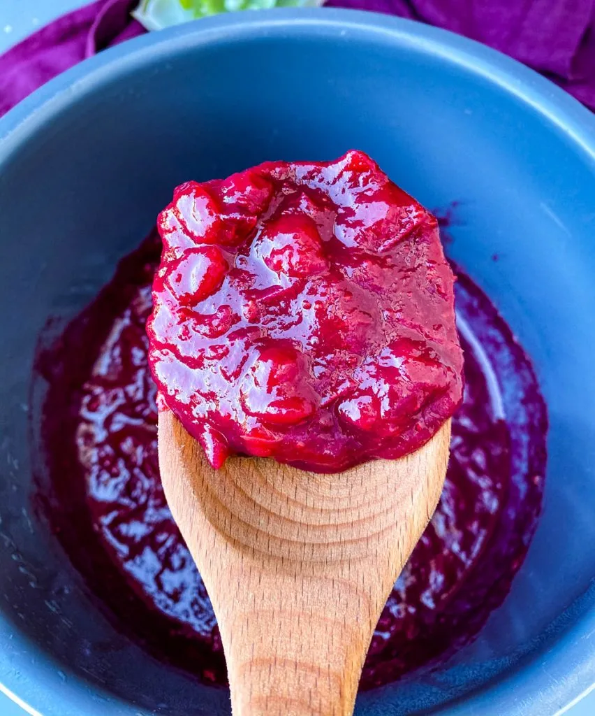 a spoonful of Instant Pot cranberry sauce in a wooden spoon