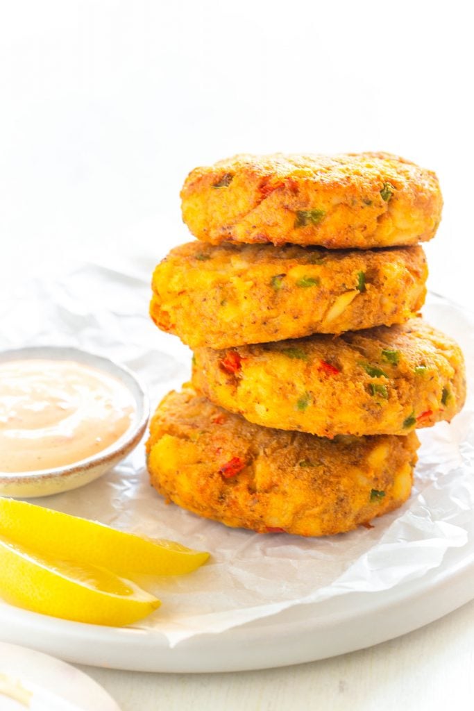 air fryer crab cakes on a white plate with fresh lemon