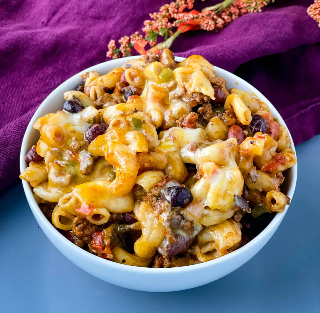 slow cooker chili mac and cheese in a white bowl