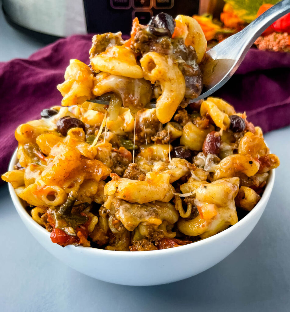 slow cooker chili mac and cheese in a white bowl