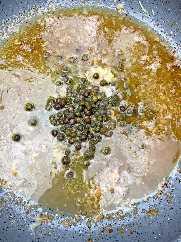 sauce and capers for keto lemon chicken picatta in a skillet