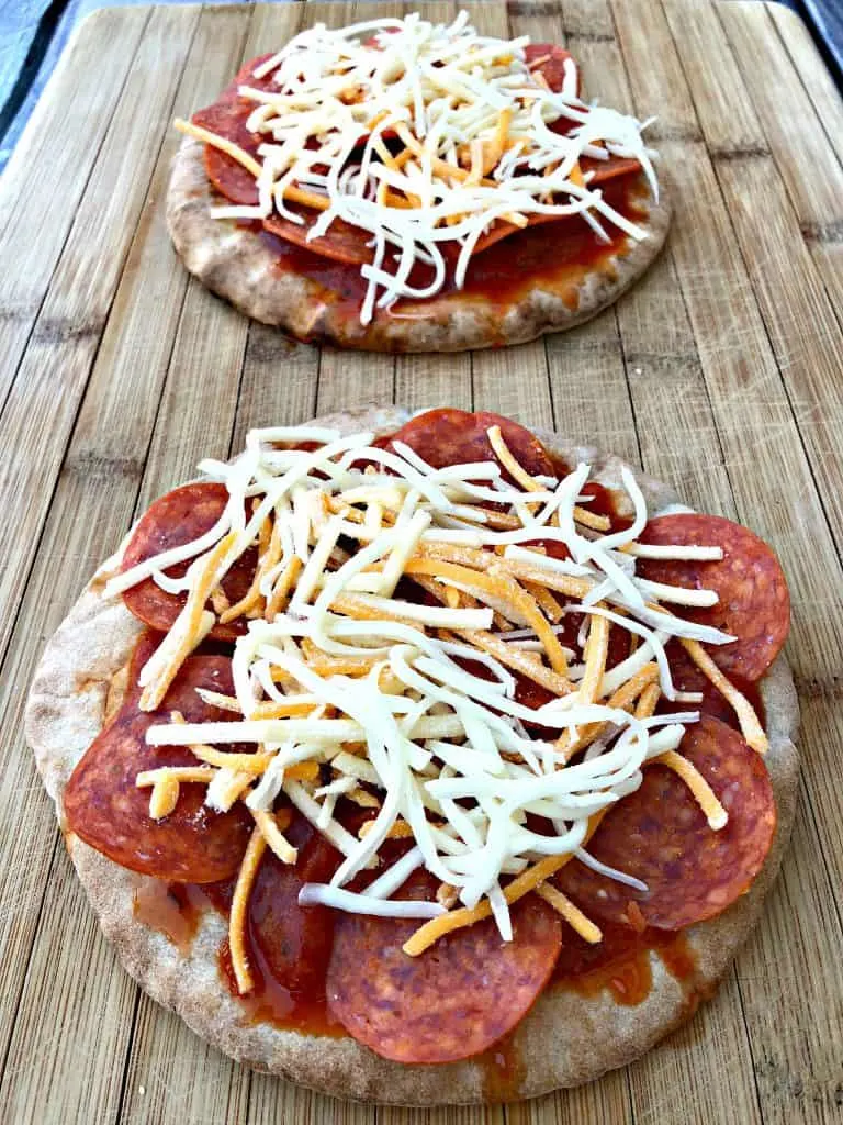 pita bread with pizza sauce, pepperoni, and cheese