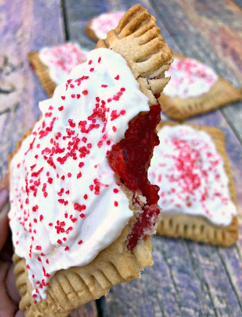 half eaten air fryer strawberry pop tarts on a multi color surface