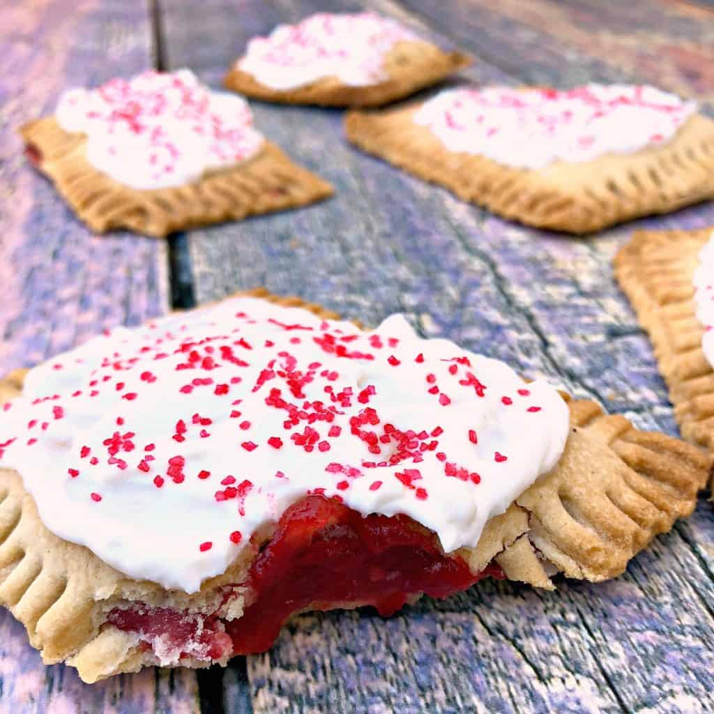 half eaten air fryer strawberry pop tarts on a multi color surface