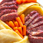 corned beef, carrots, and cabbage on a white plate