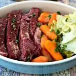 corned beef, carrots, and cabbage on a white plate