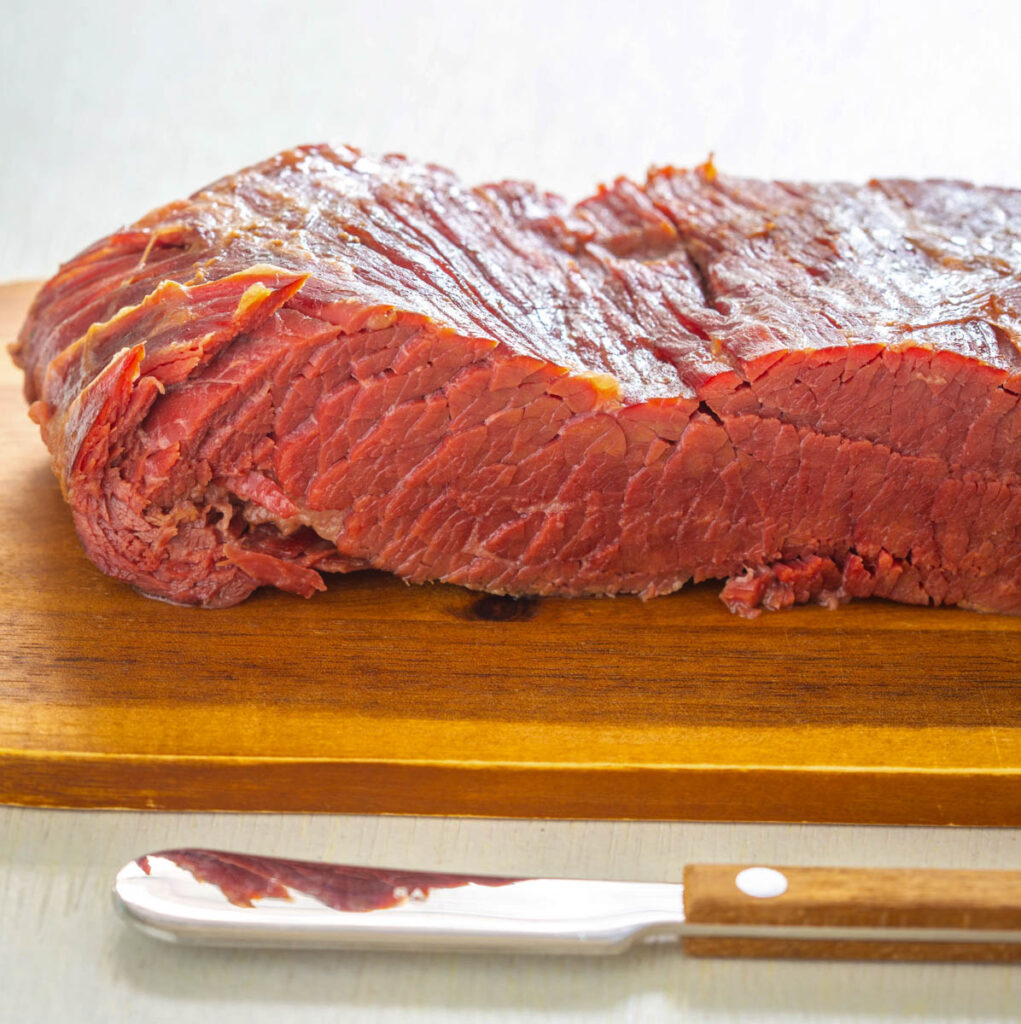 cooked corned beef on a cutting board