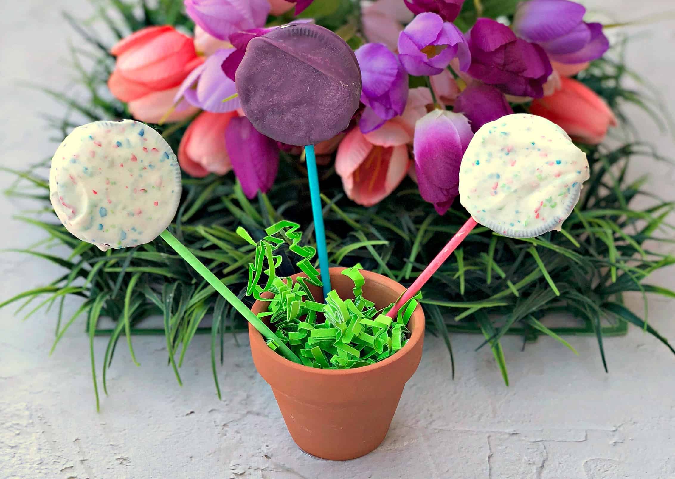 3 oreo easter dessert pops in a small planter with green easter grass