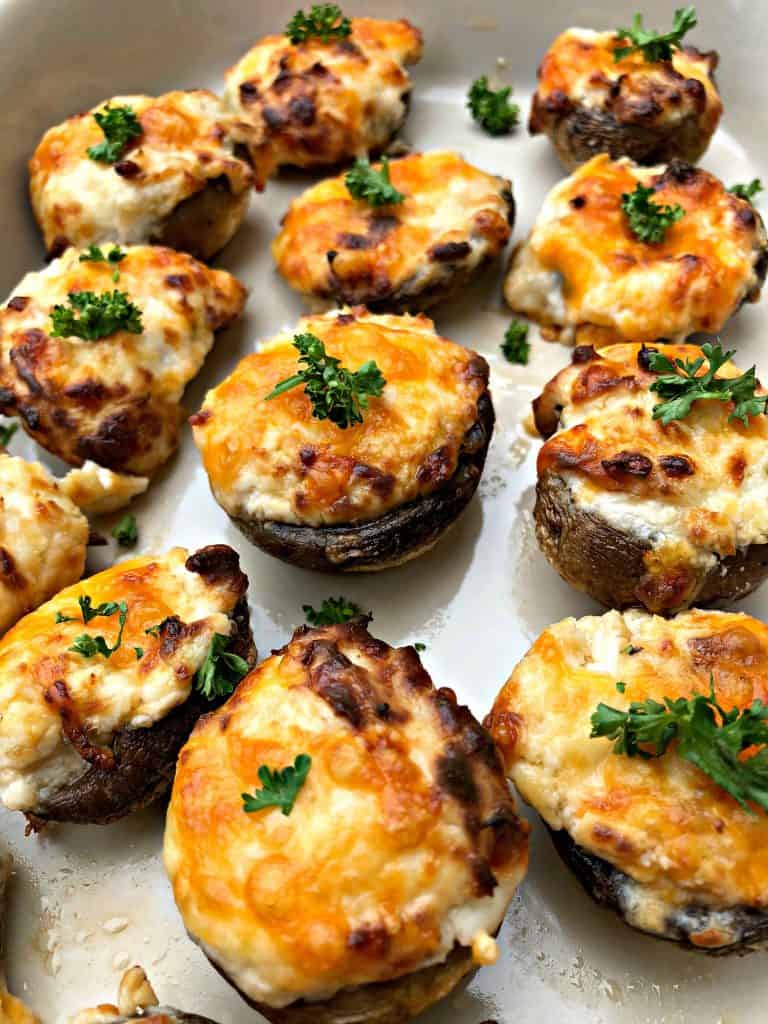 cooked stuffed mushroom with cheese on a white plate