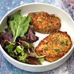 air fryer pork chops in a white bowl with salad